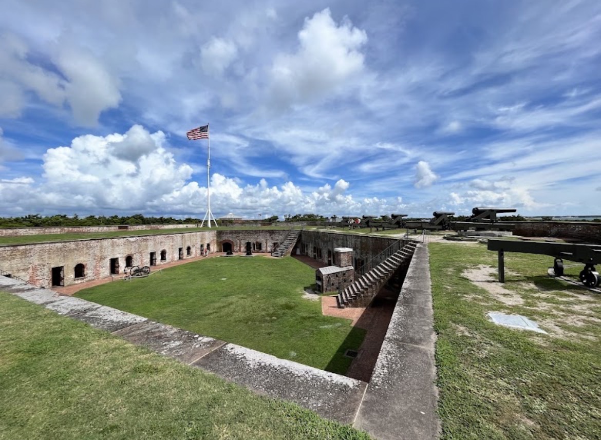 Parade ground, cannons and the American flag inside Fort Macon State Park in Atlantic Beach, NC