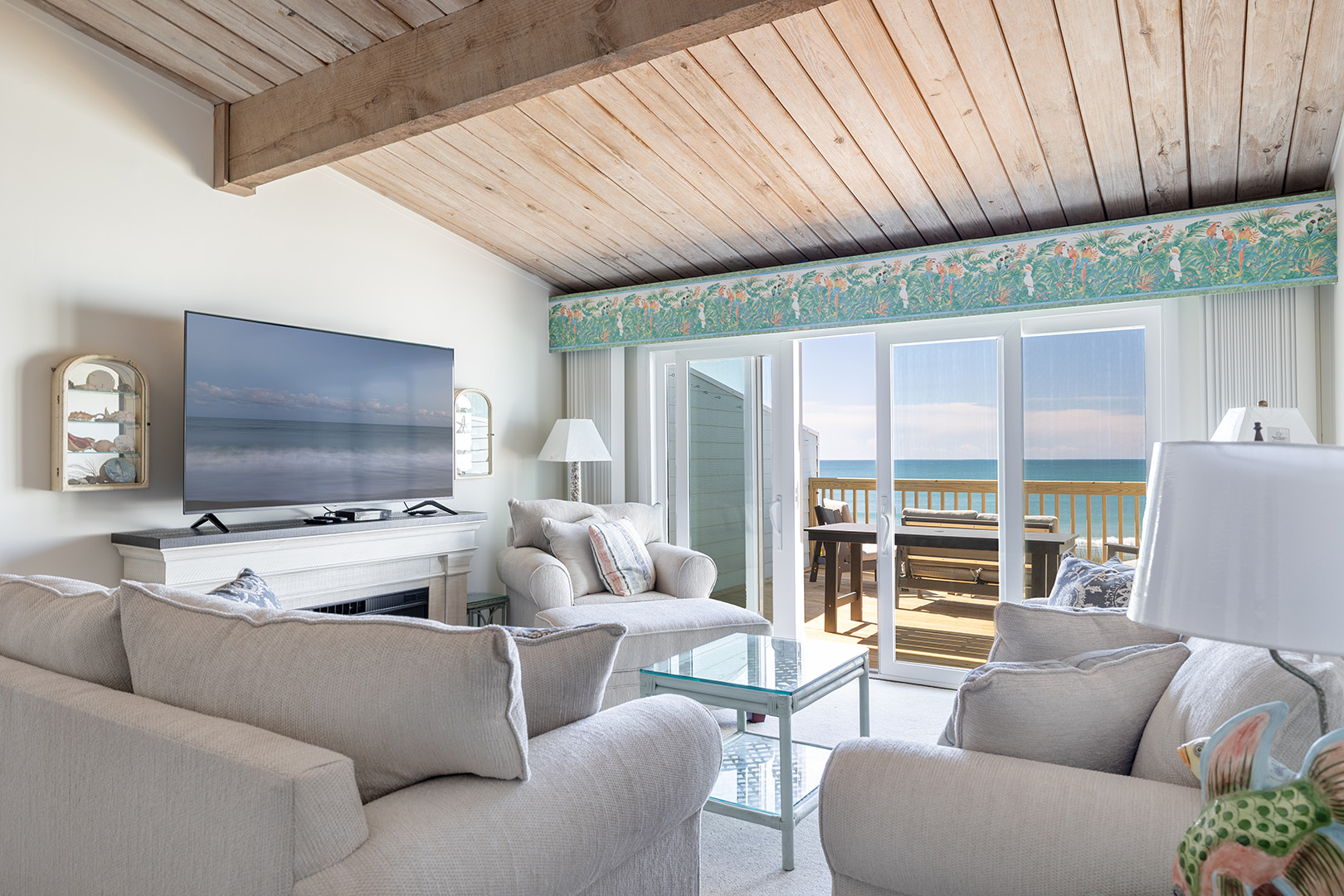 Living room opening onto the oceanfront deck at Coral Shores 12