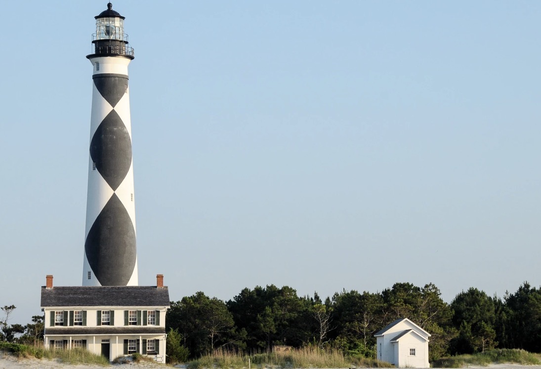 The black-and-white diamond-patterned Cape Lookout Lighthouse and keepers' quarters